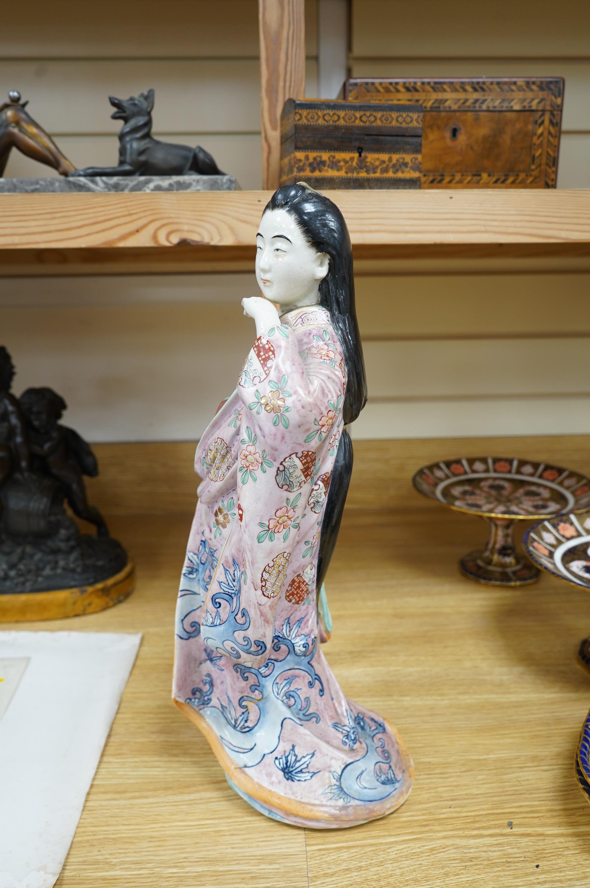 A Japanese earthenware figure of a lady, circa 1900, 46cm. Condition - poor